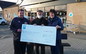 Volunteers holding cheque outside the Co-op store in Balmedie